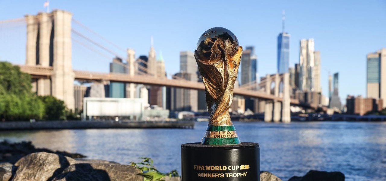 Image of the FIFA Men's World Cup trophy with the Manhattan skyline behind it